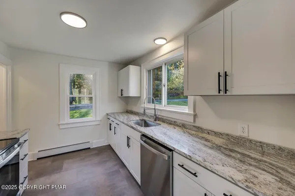 a kitchen that has a sink and a window in it