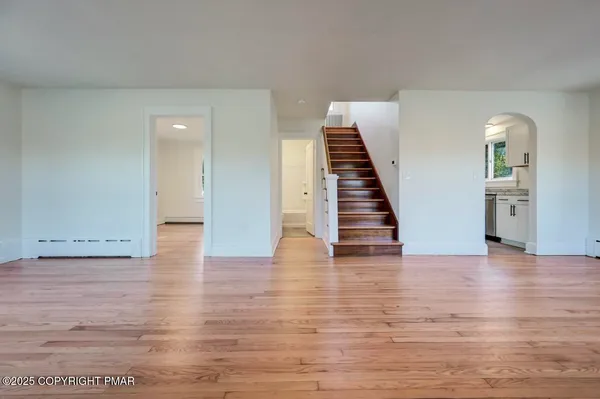 a view of a room with wooden floor