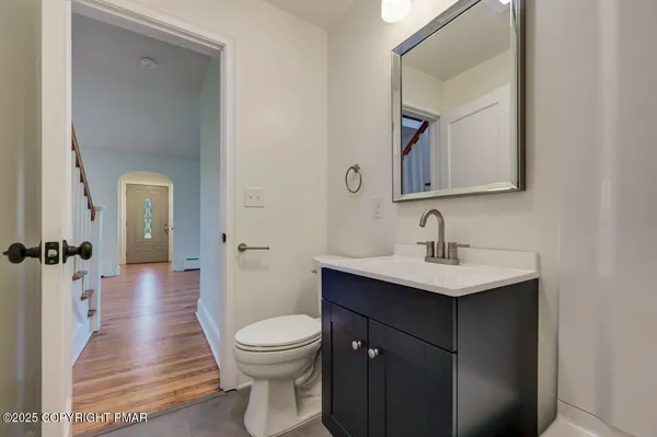 a bathroom with a sink a toilet a mirror and vanity