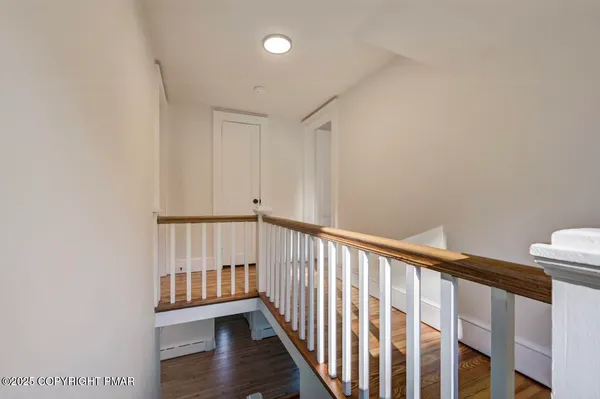 a view of hallway with wooden floor