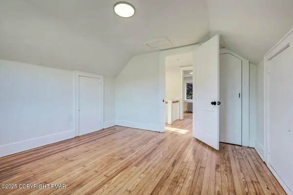 a view of a room with wooden floor and a sink