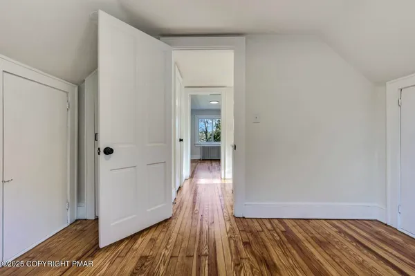 a view of an empty room and wooden floor
