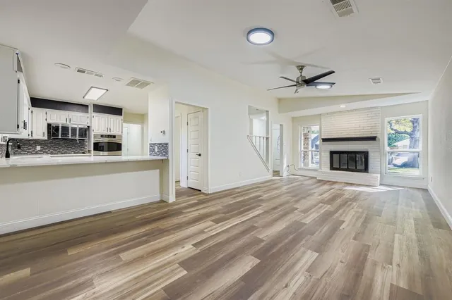a view of a kitchen and an empty room