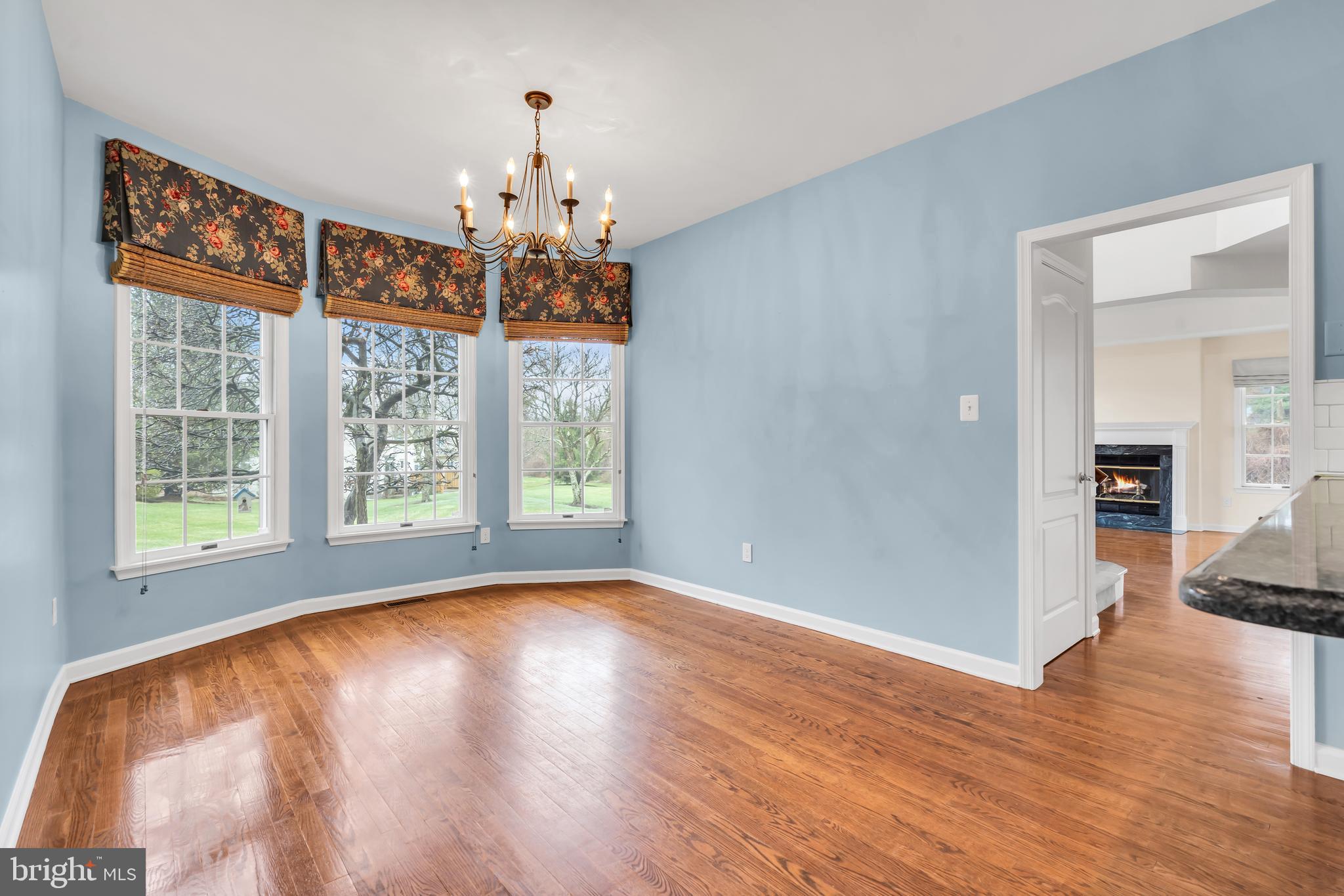 21 Wilkinson Way Princeton, NJ 08540 - Photo 13 of 43 a view of a livingroom with wooden floor a chandelier and windows