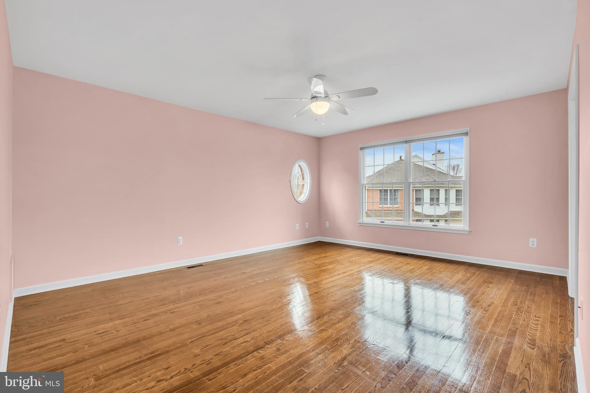 21 Wilkinson Way Princeton, NJ 08540 - Photo 25 of 43 an empty room with wooden floor chandelier fan and windows