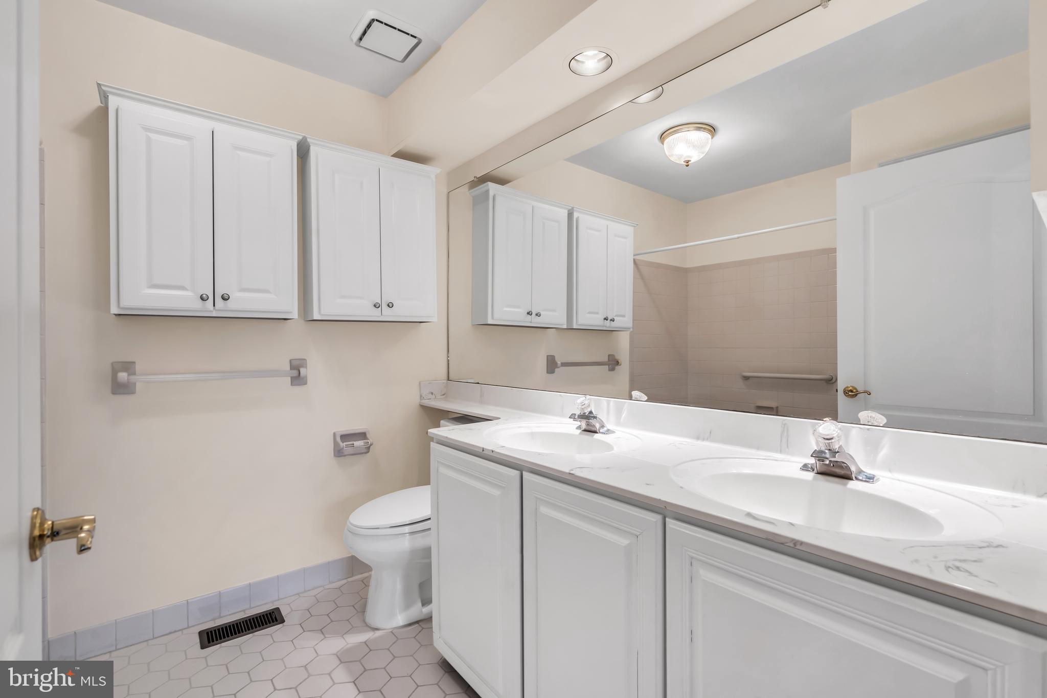 21 Wilkinson Way Princeton, NJ 08540 - Photo 31 of 43 a bathroom with a sink a toilet and a mirror