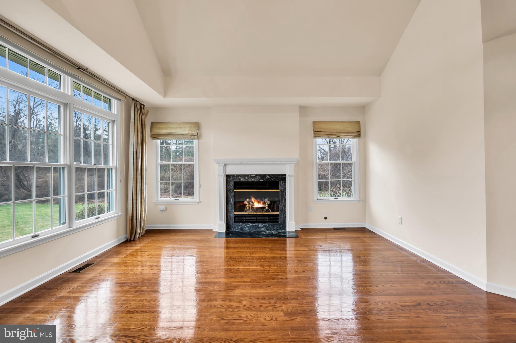 21 Wilkinson Way Princeton, NJ 08540 - Photo 6 of 43 a view of an empty room with wooden floor and a window