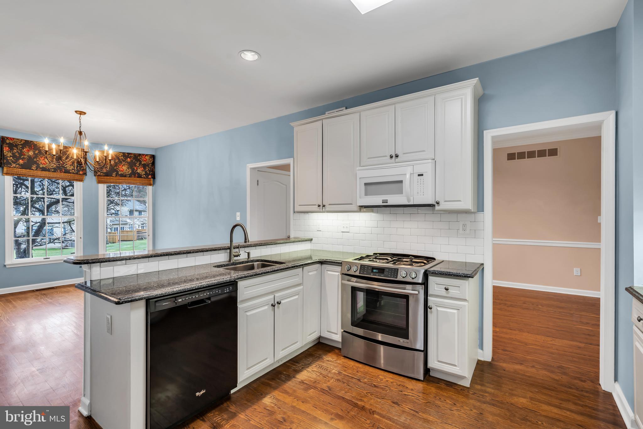 21 Wilkinson Way Princeton, NJ 08540 - Photo 9 of 43 a kitchen with stainless steel appliances granite countertop a stove a sink and a microwave