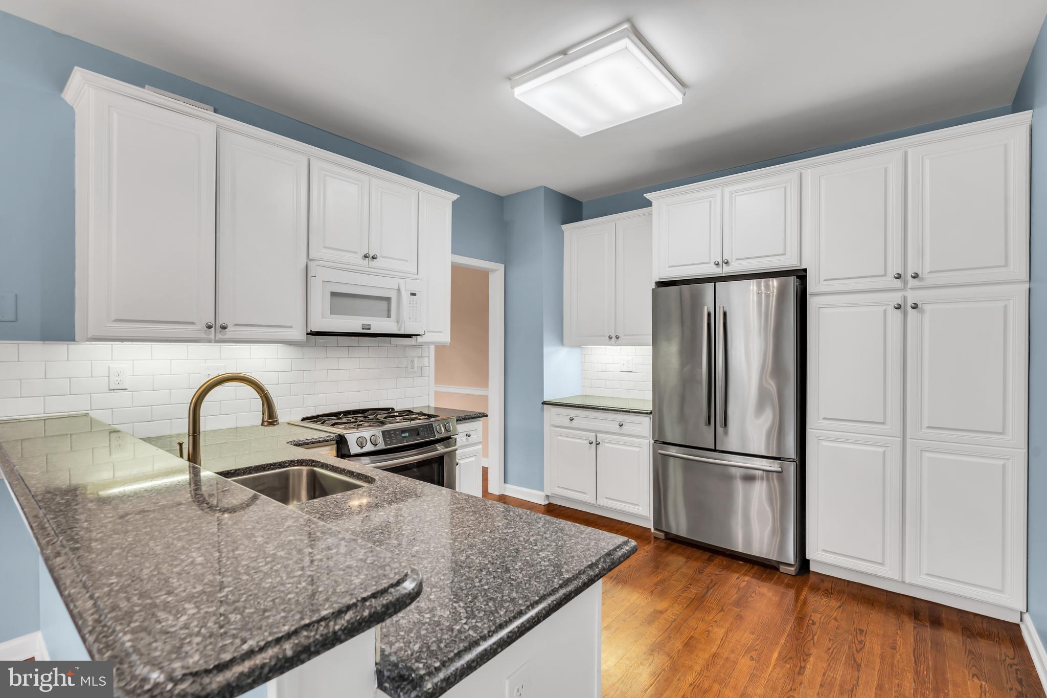 21 Wilkinson Way Princeton, NJ 08540 - Photo 10 of 43 a kitchen with granite countertop a refrigerator sink and cabinets