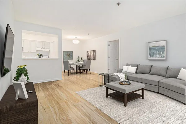 a living room with furniture and wooden floor