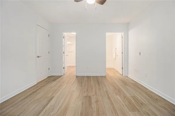 a view of an empty room with wooden floor