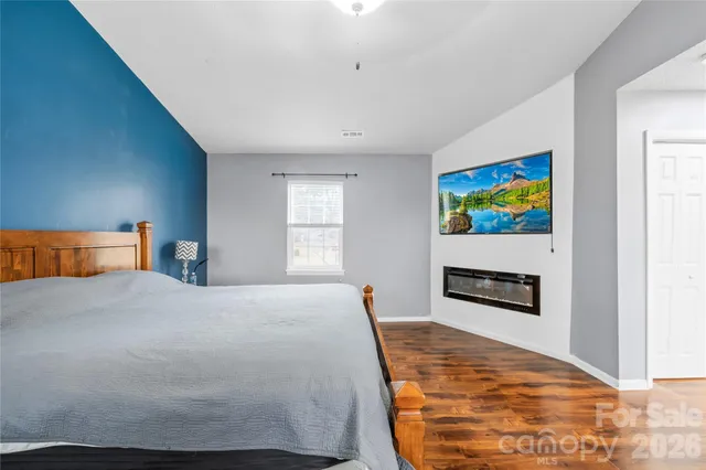 a bedroom with bed and painting on the wall