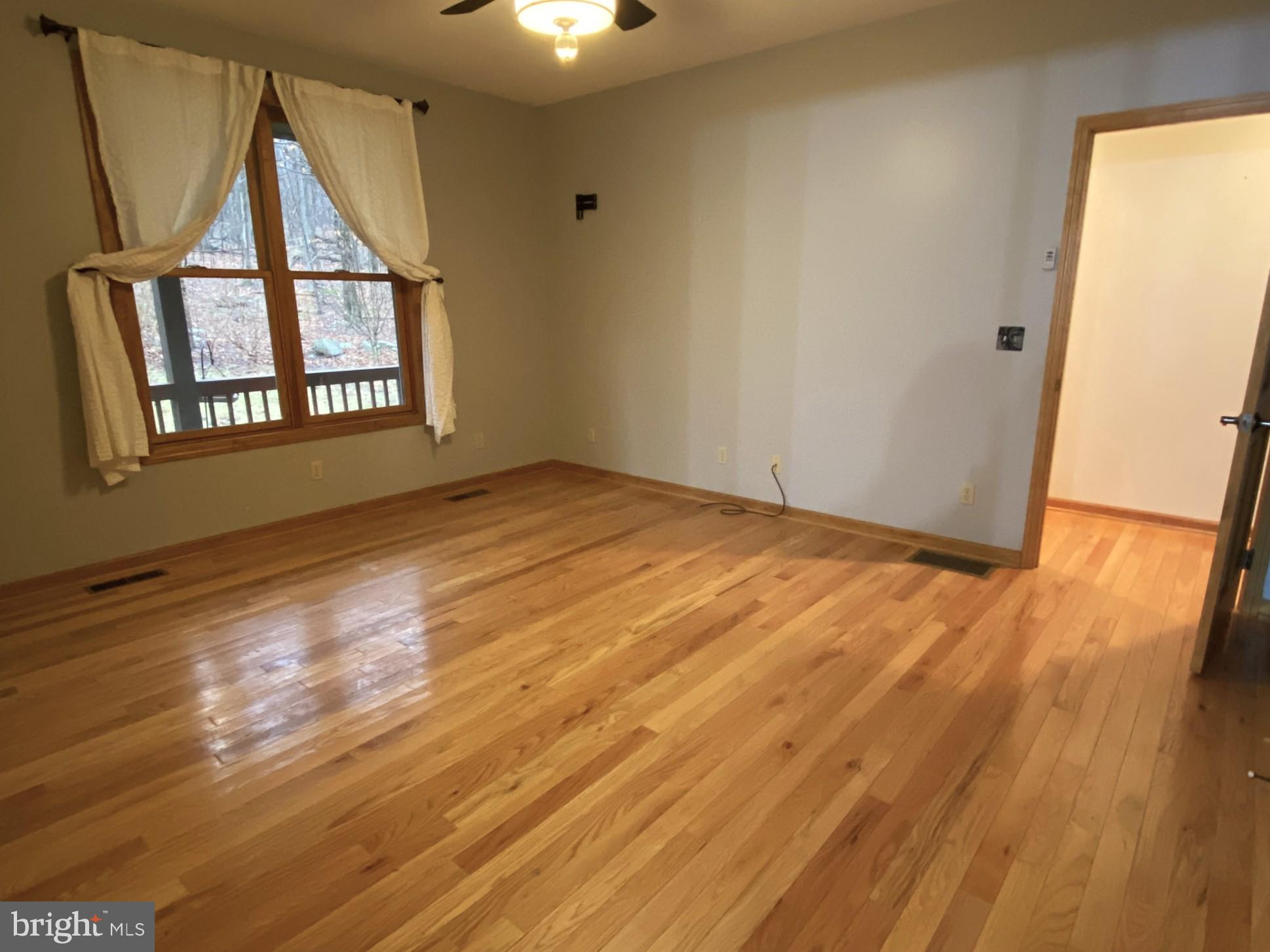 10915 Rachael Avenue Midlothian, MD 21543 - Photo 13 of 52 a view of an empty room and wooden floor