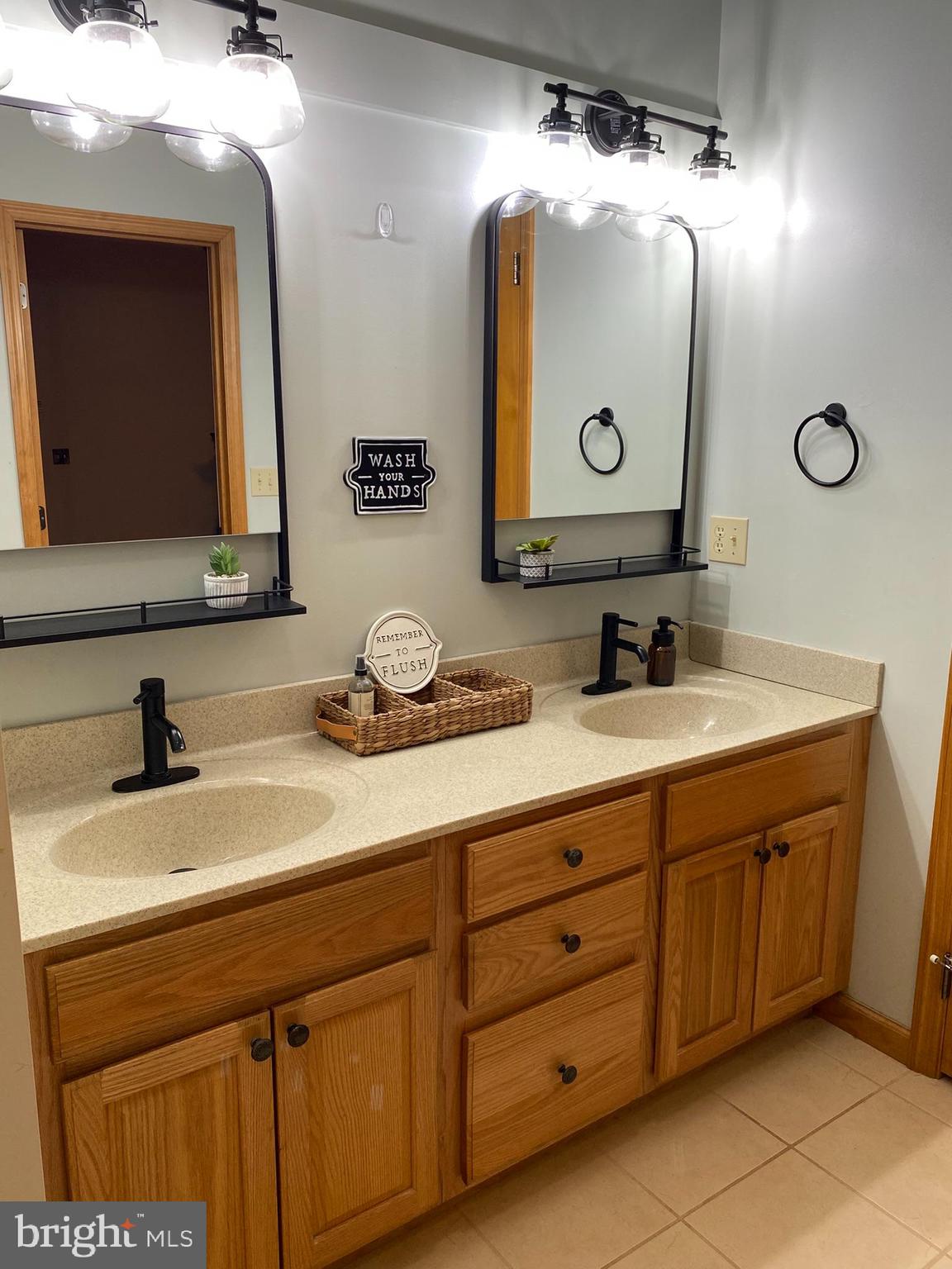 10915 Rachael Avenue Midlothian, MD 21543 - Photo 15 of 52 a bathroom with a double vanity sink and a mirror