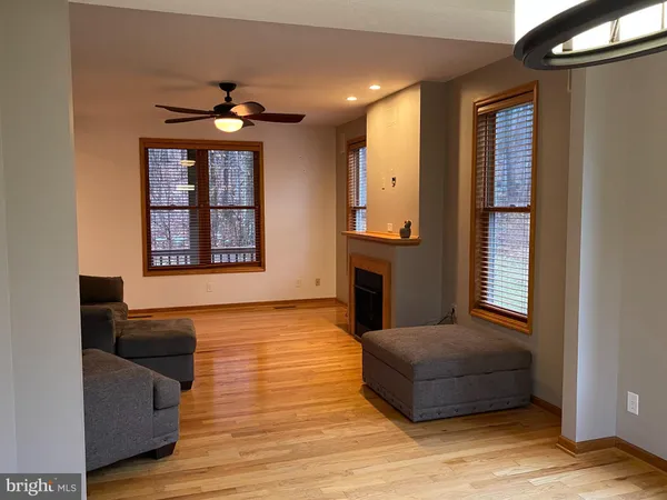 a bedroom with a bed a mirror and a large window