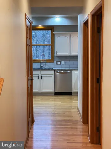 a kitchen with granite countertop a stove and cabinets