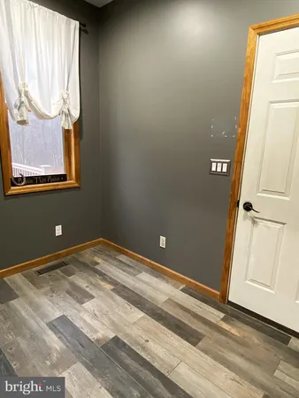 a bedroom with bed and a large window