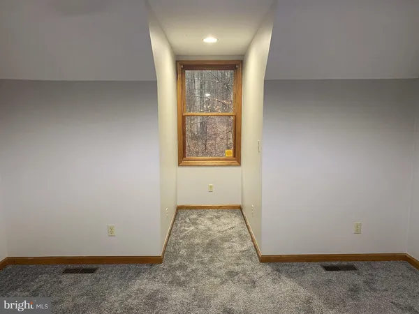 a bedroom with a baby bed a couch and a baby crib
