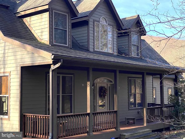 a view of a house with wooden fence and large windows