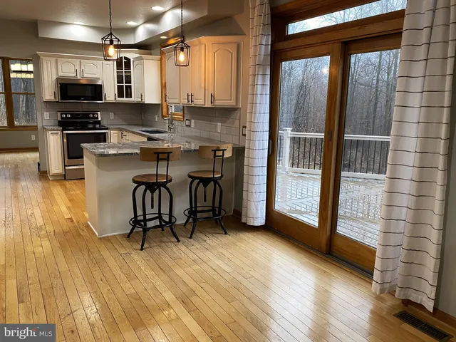 a kitchen with stainless steel appliances a refrigerator and a stove top oven