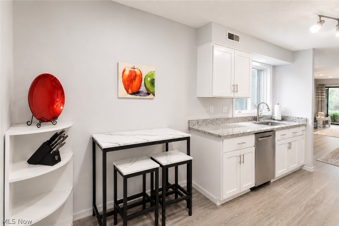 16575 Wren Road, Unit 3C Chagrin Falls, OH 44023 - Photo 7 of 29 Modern kitchen featuring white cabinetry with brushed nickel hardware