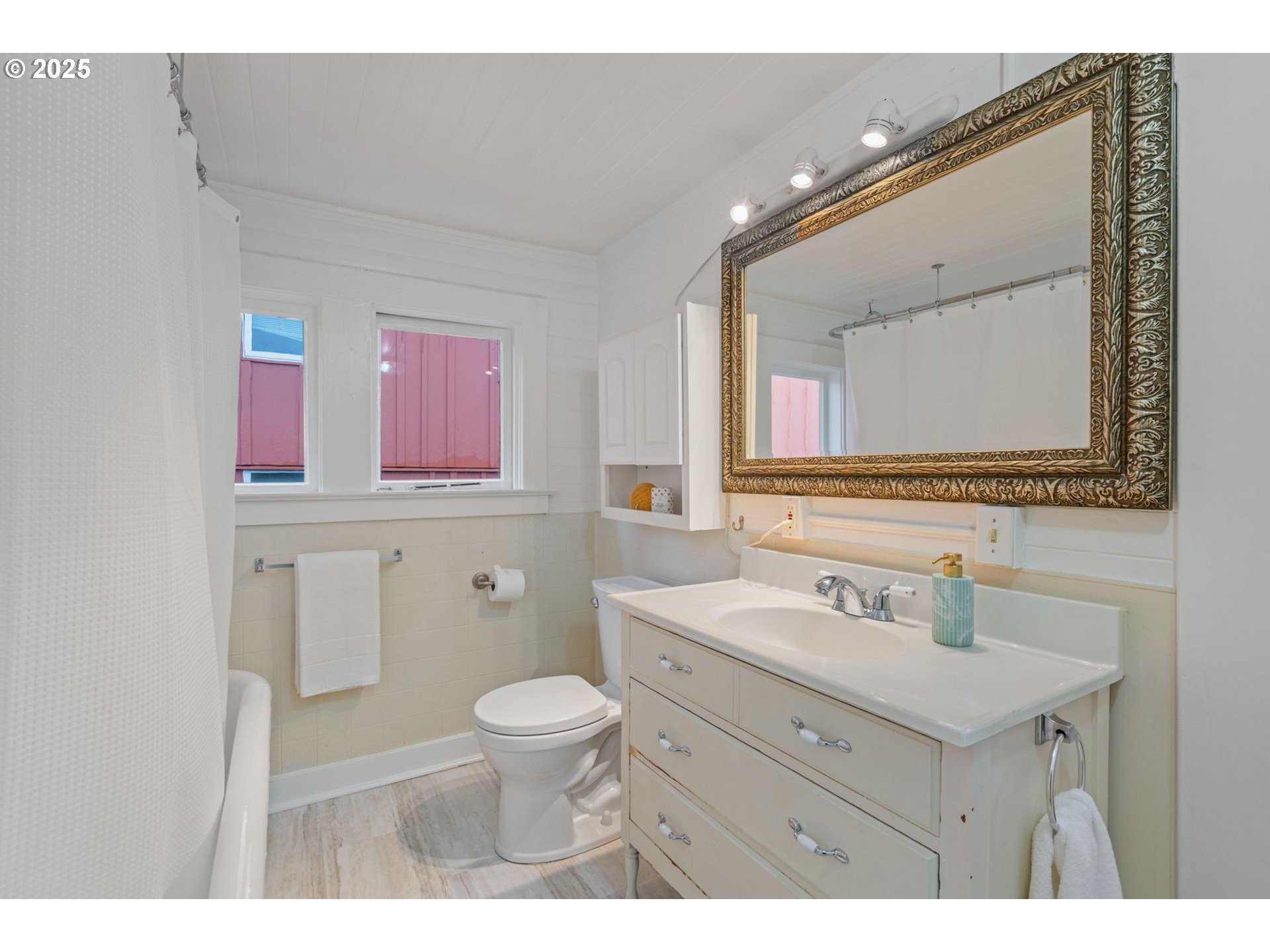 5415 Northeast 14th Place Portland, OR 97211 - Photo 23 of 38 a bathroom with a sink vanity mirror and toilet