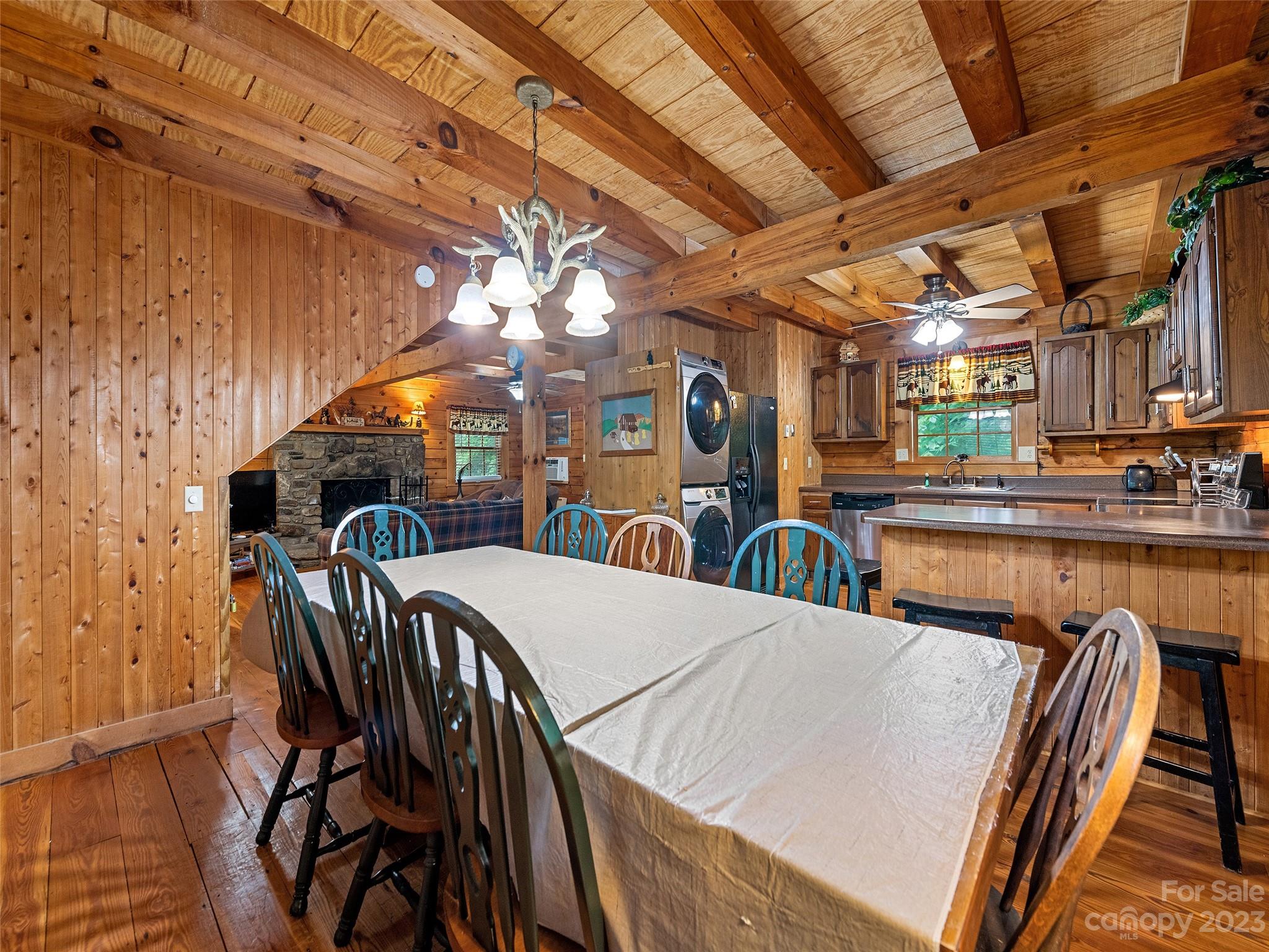 81 Railroad Grade Road Maggie Valley, NC 28751 - Photo 15 of 38 a view of a dining room with furniture and wooden floor