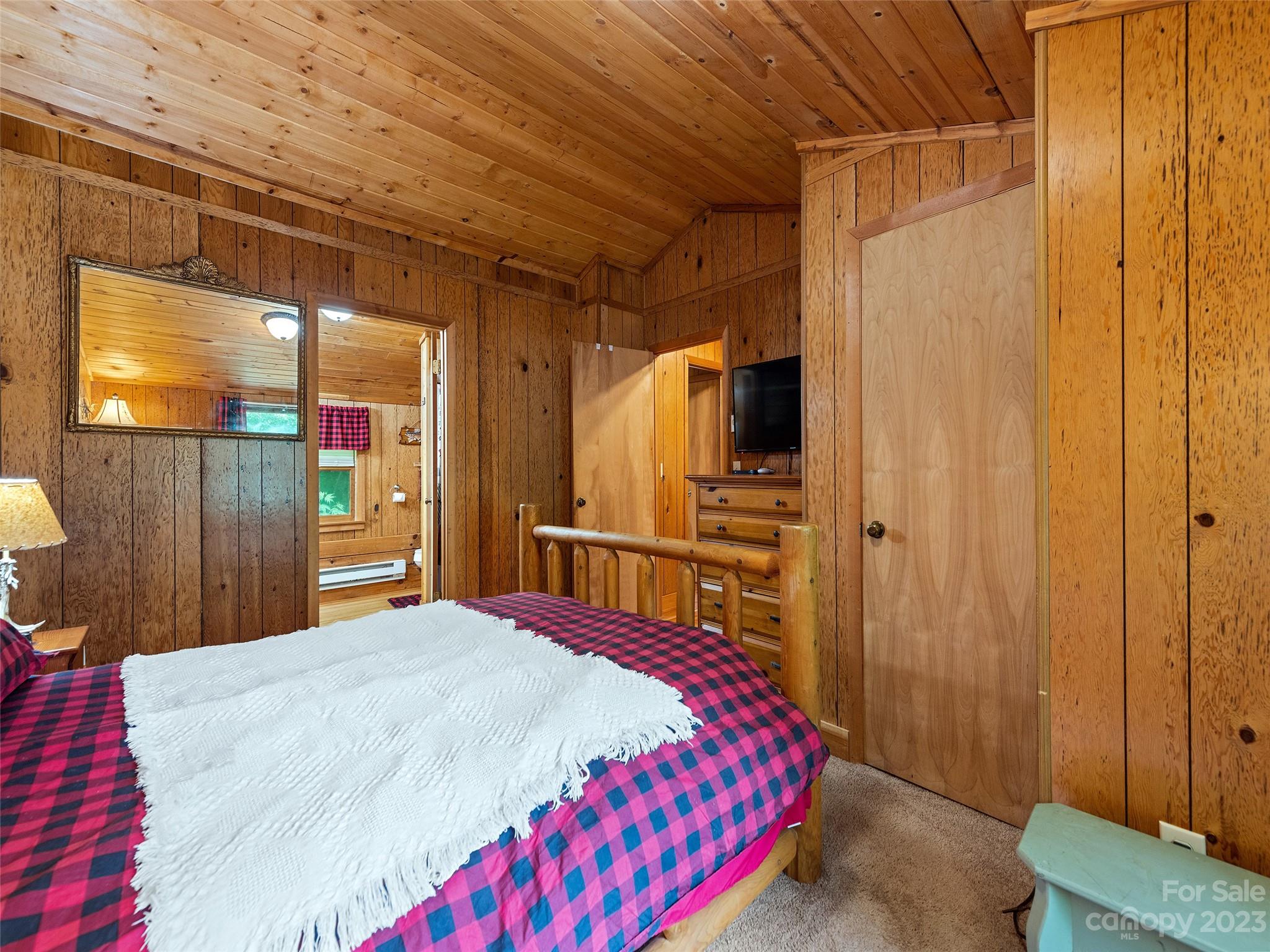 81 Railroad Grade Road Maggie Valley, NC 28751 - Photo 20 of 38 a bedroom with a bed and a mirror