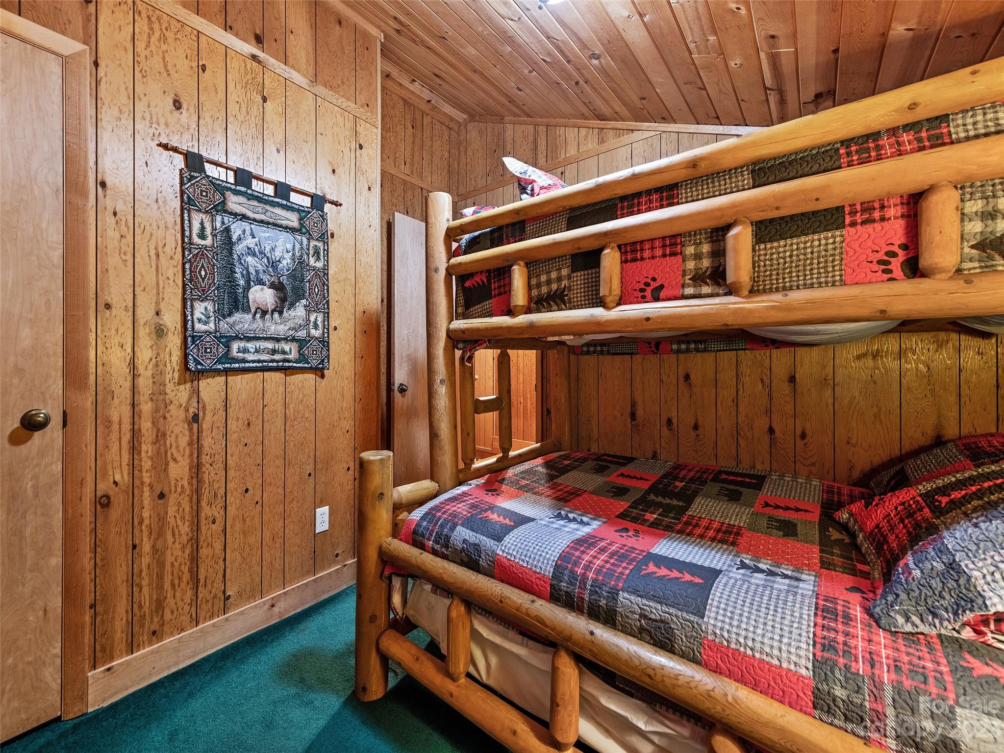 81 Railroad Grade Road Maggie Valley, NC 28751 - Photo 27 of 38 a bedroom with furniture and a book shelf
