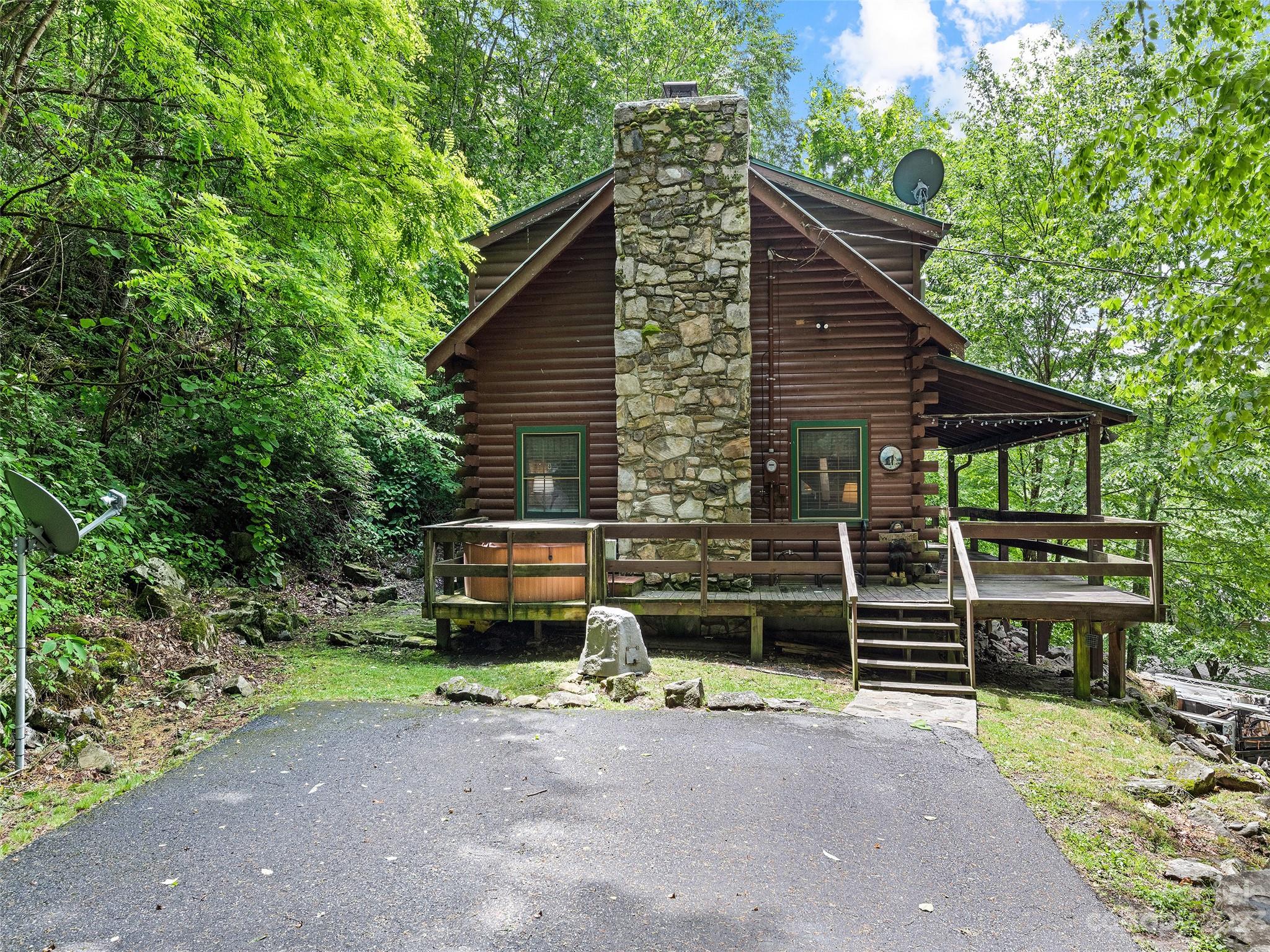 81 Railroad Grade Road Maggie Valley, NC 28751 - Photo 37 of 38 a front view of a house with a garden