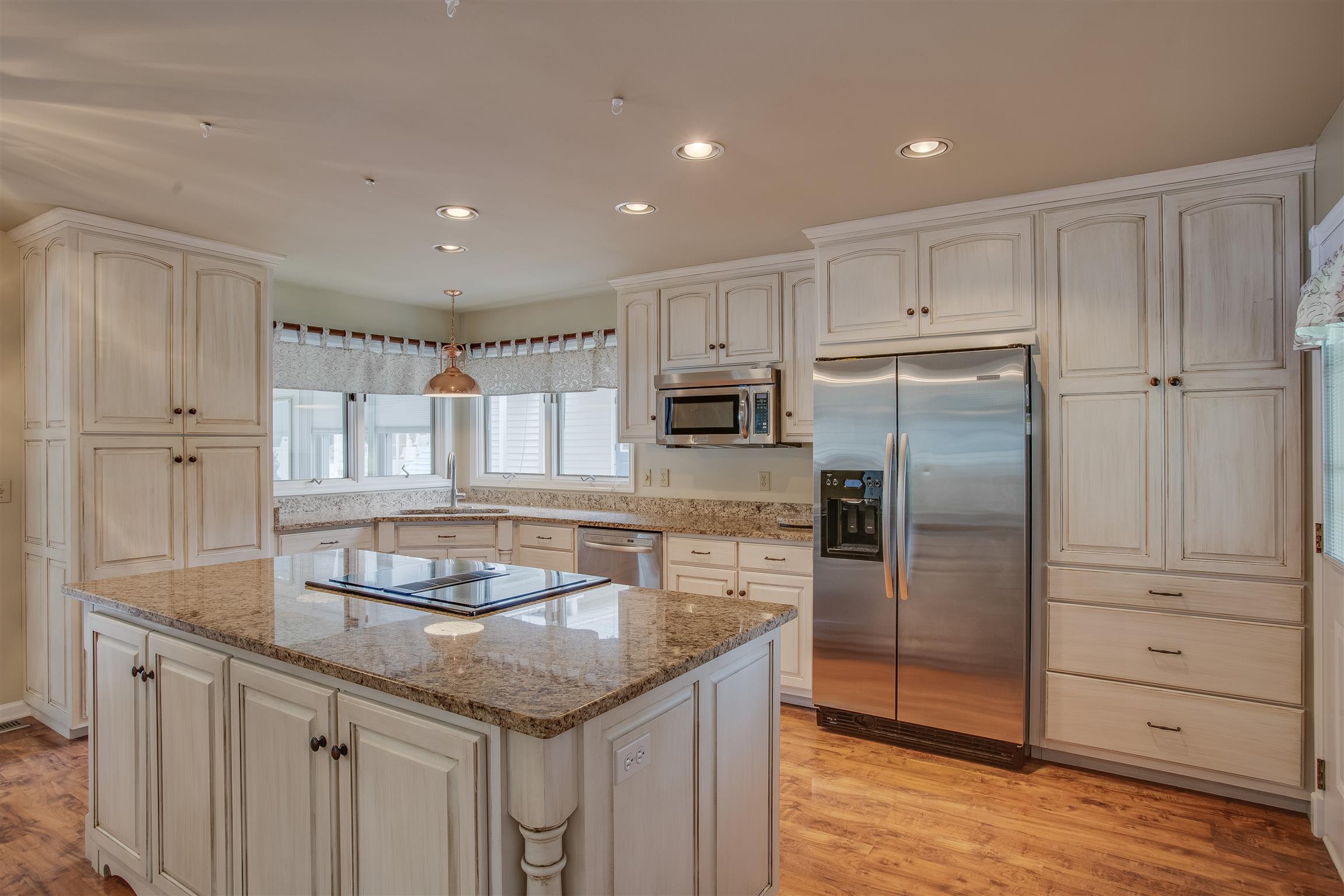 1157 Roseland Road Columbia, TN 38401 - Photo 11 of 30 a kitchen with granite countertop a refrigerator and wooden cabinets