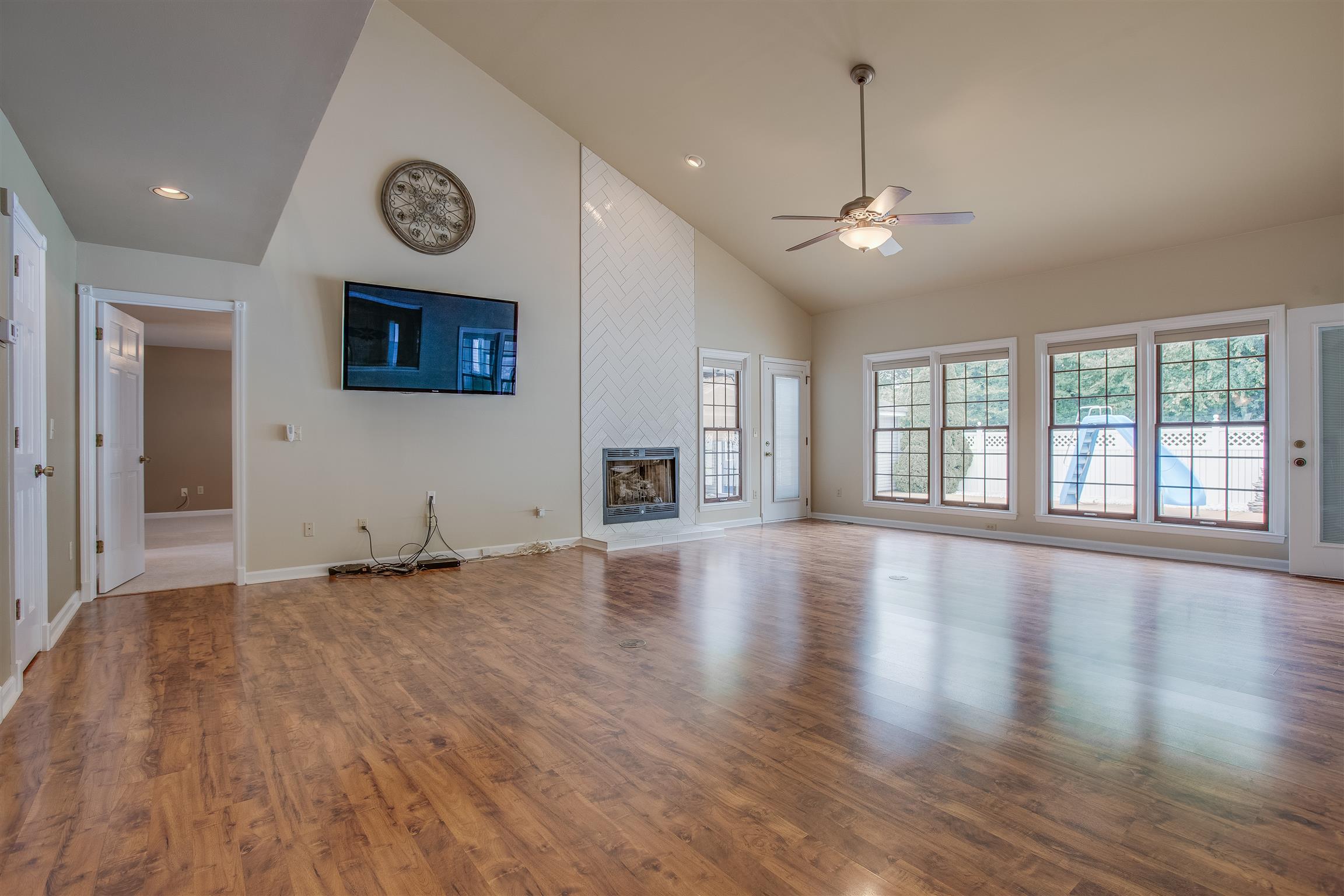 1157 Roseland Road Columbia, TN 38401 - Photo 9 of 30 an empty room with wooden floor and windows