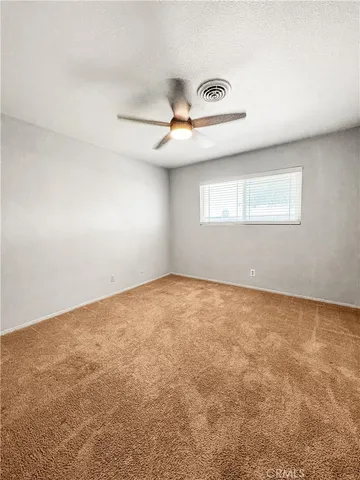 an empty room with a empty space and windows