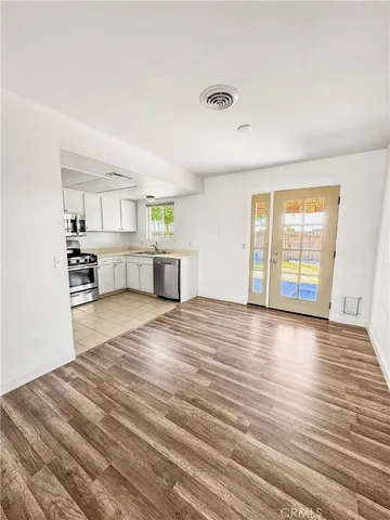 a view of a refrigerator in kitchen and a window