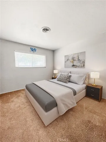 a bedroom with a bed and a couch