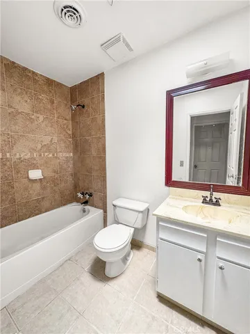 a bathroom with a sink a toilet a mirror a bathtub and shower