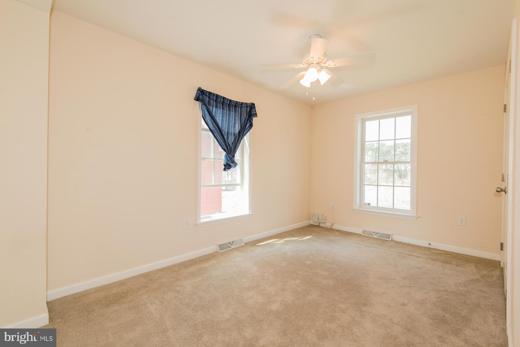 1325 Tree Side Court Odenton, MD 21113 - Photo 13 of 20 an empty room with chandelier fan and windows