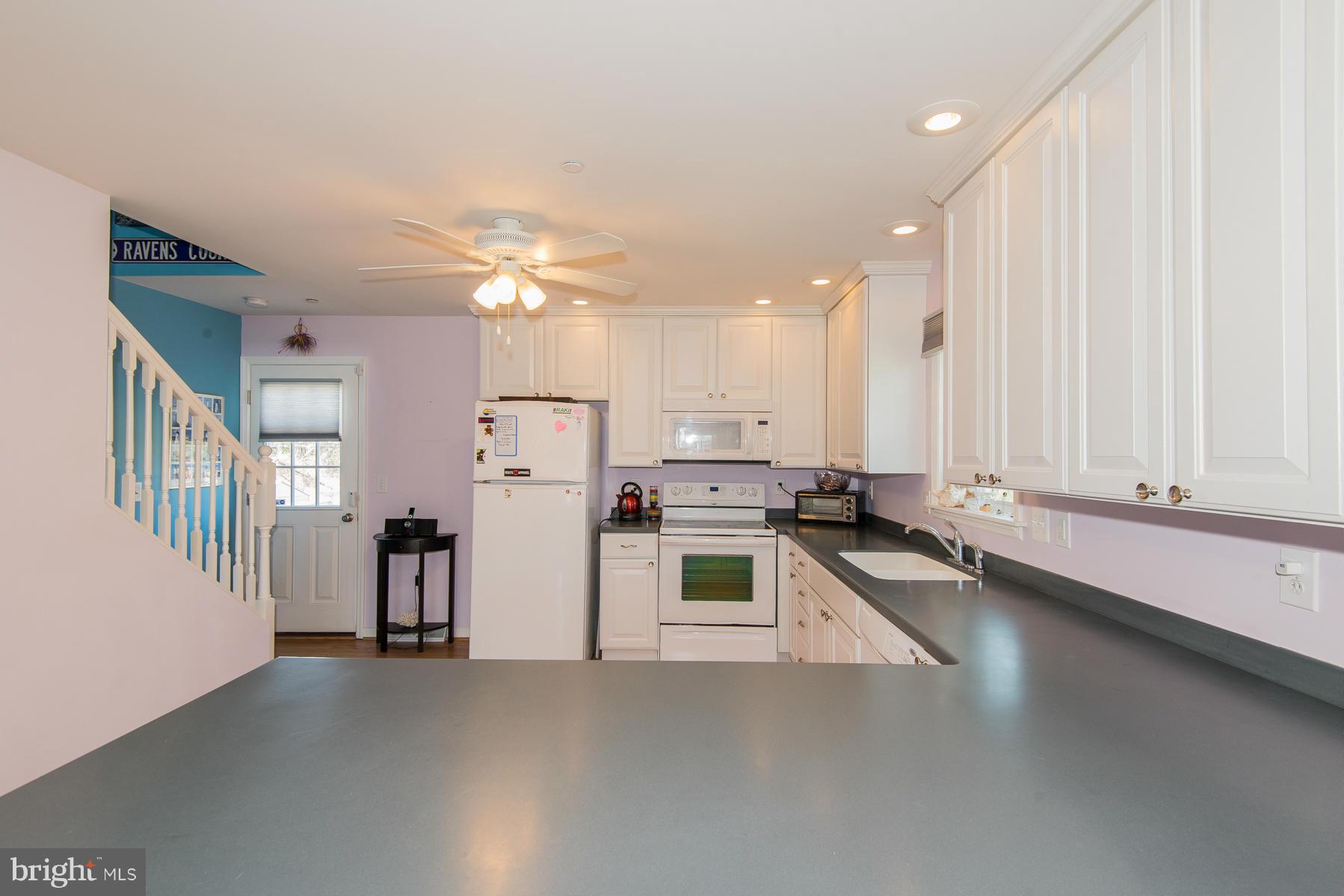 1325 Tree Side Court Odenton, MD 21113 - Photo 6 of 20 a view of a kitchen with a sink and a large window
