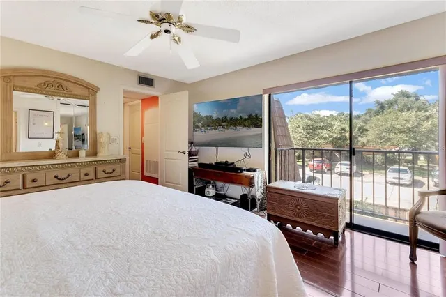 a bedroom with a bed and large windows