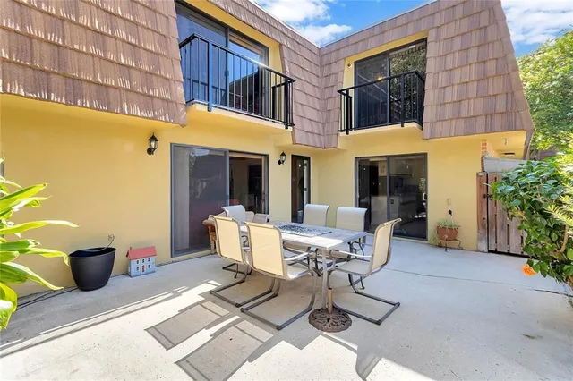 a view of a patio with table and chairs and potted plants