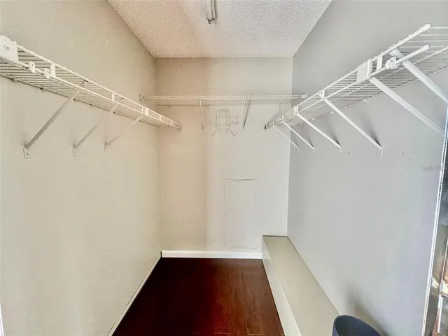 a view of walk in closet with empty racks