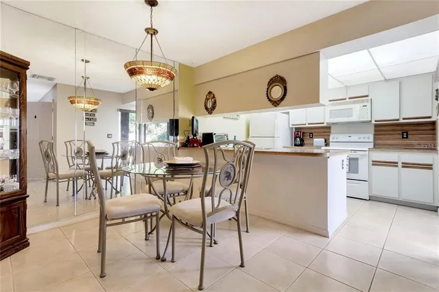 a view of kitchen and dining area with a large window