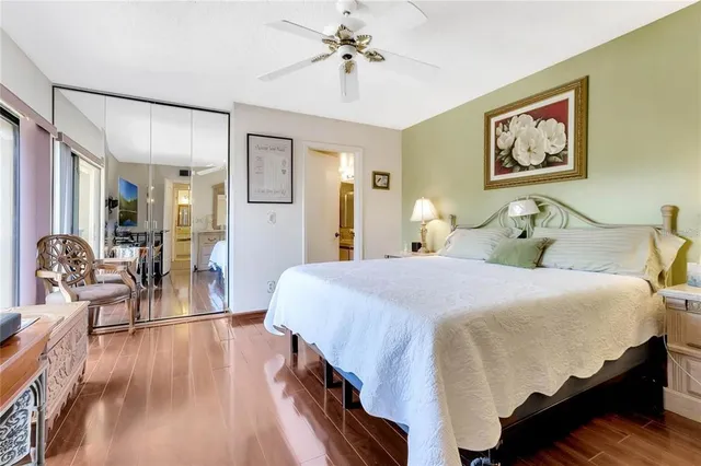 a bedroom with bed and wooden floor