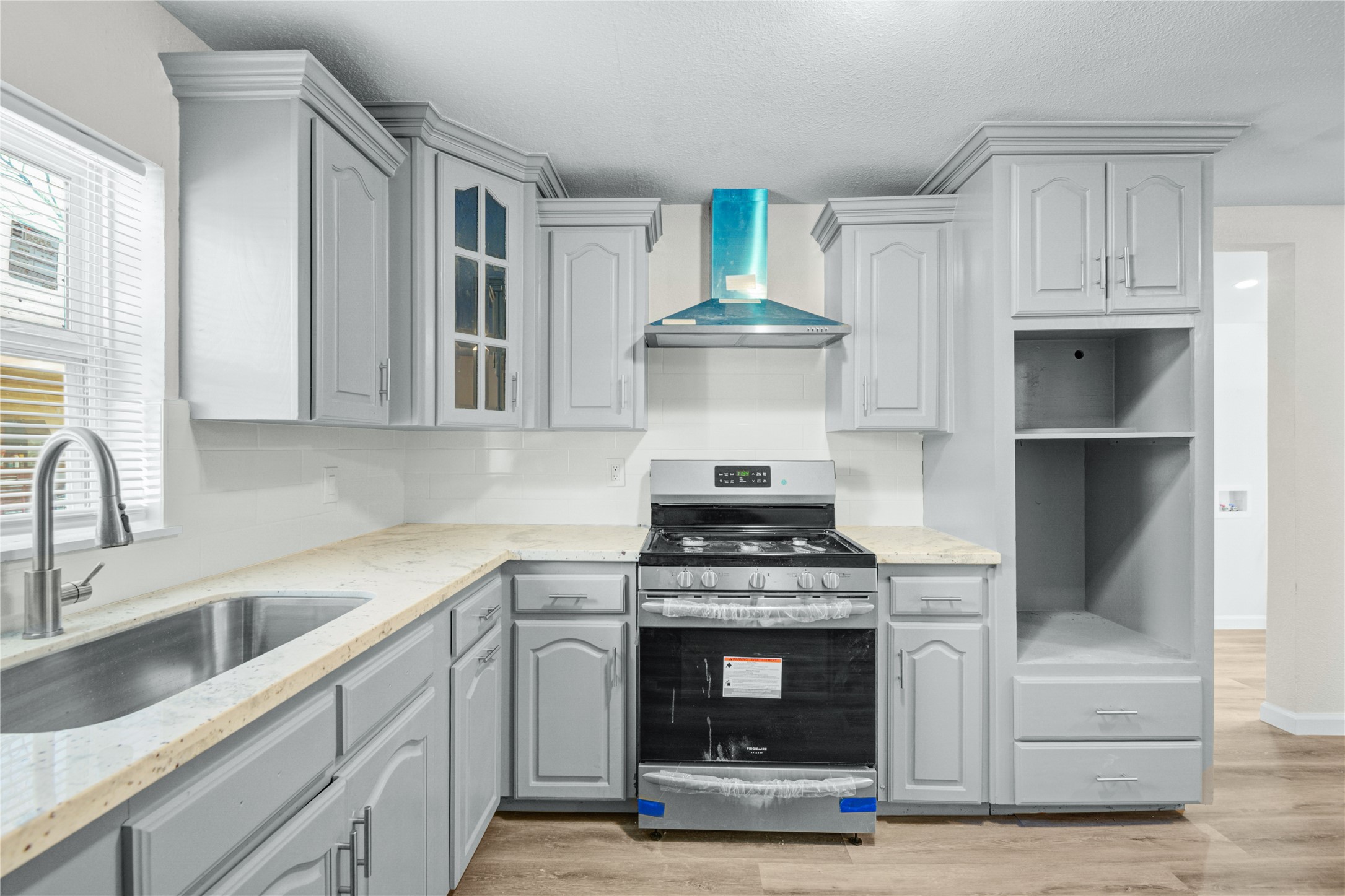 207 East Bernard Street Clute, TX 77531 - Photo 13 of 25 a kitchen with stainless steel appliances granite countertop a stove and a sink