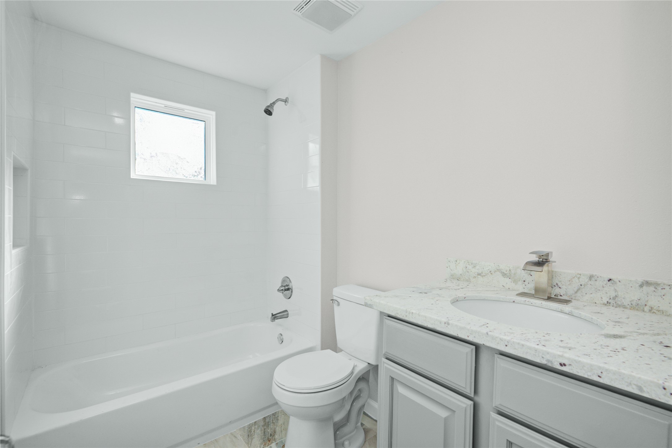 207 East Bernard Street Clute, TX 77531 - Photo 16 of 25 a bathroom with a granite countertop sink a toilet and bathtub