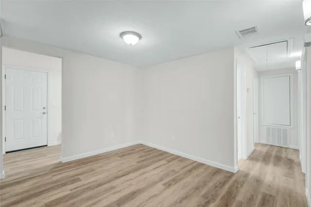 a view of a room with wooden floor