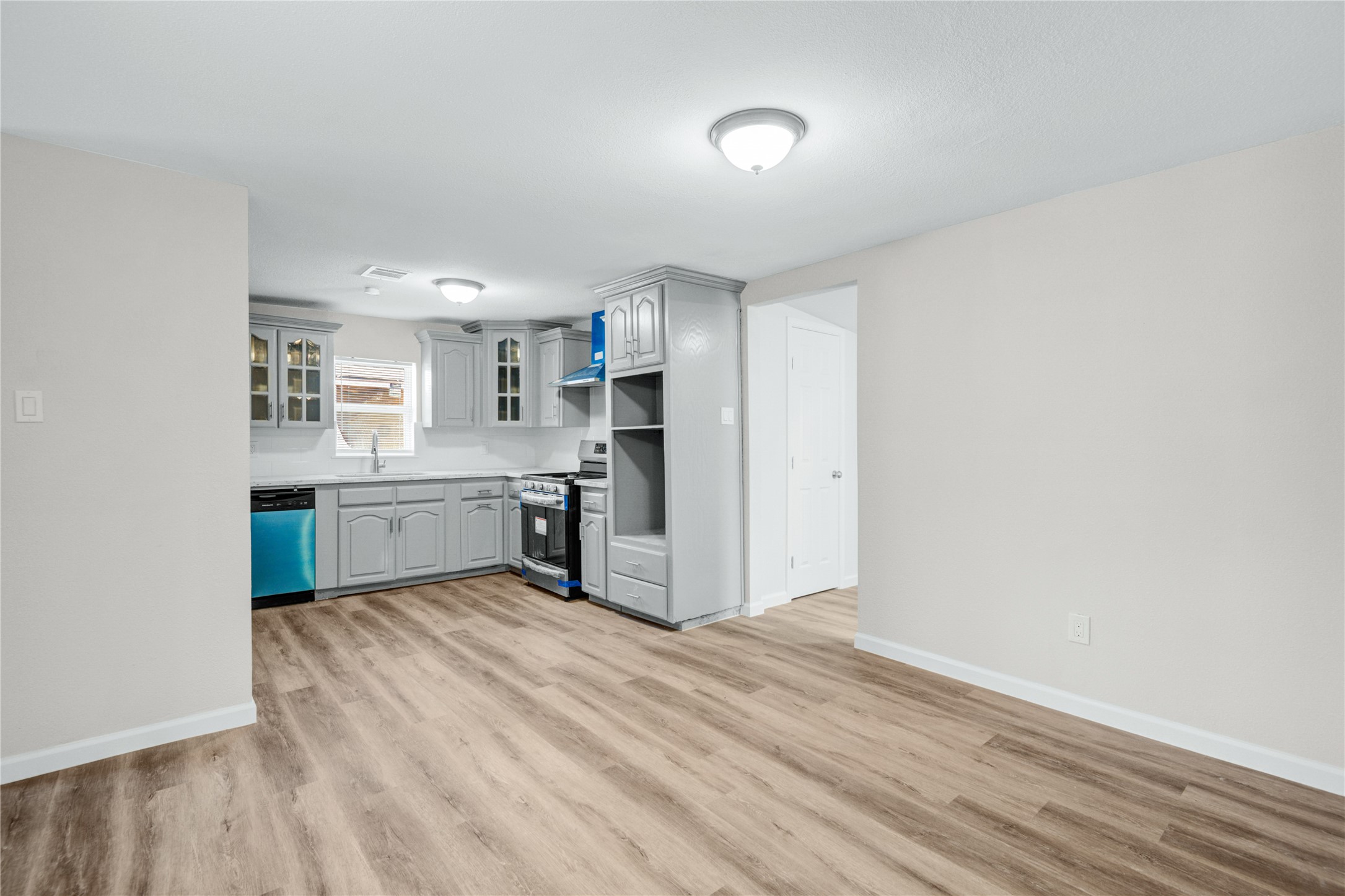 207 East Bernard Street Clute, TX 77531 - Photo 9 of 25 a kitchen with stainless steel appliances a sink and cabinets