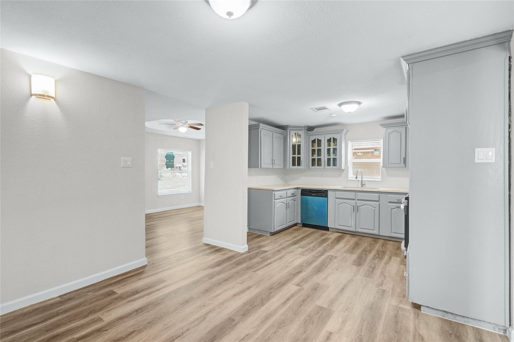 207 East Bernard Street Clute, TX 77531 - Photo 10 of 25 a room with a wooden floor and windows
