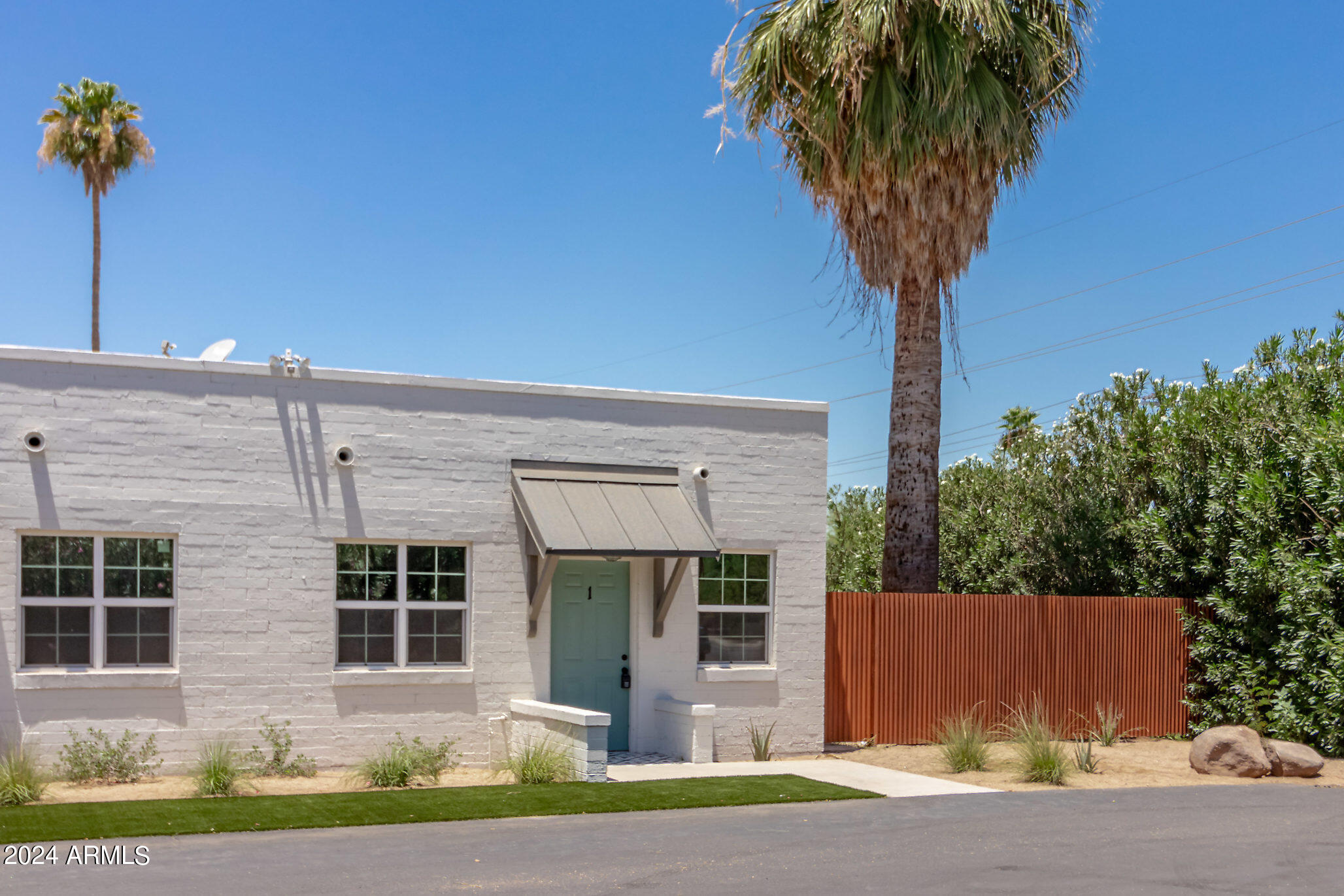 1649 East Oak Street, Unit 1 Phoenix, AZ 85006 - Photo 14 of 14 a front view of a house with a yard and potted plants