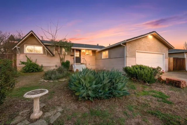 a front view of a house with garden